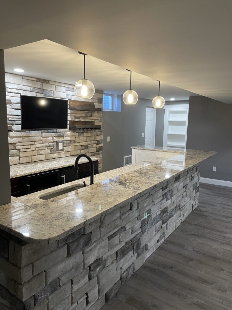 Finished Basement Remodel. Wetbar with decorative stone and granite counter-tops